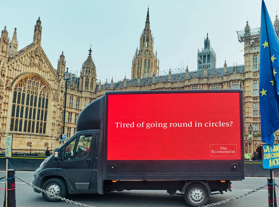 ‘Tired of going round in circles?’ 
The Economist marks another Brexit vote by driving a special message round (and round) Parliament Square